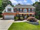 Charming brick home featuring a well-manicured lawn and traditional architectural details at 3965 Hamilton View Way, Dacula, GA 30019