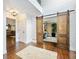 Foyer featuring shiplap walls, a jute rug, and sliding barn doors to the office at 3965 Hamilton View Way, Dacula, GA 30019