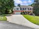 Inviting brick home featuring lush landscaping and a convenient two-car garage with driveway at 3965 Hamilton View Way, Dacula, GA 30019