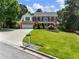 Charming brick home with well-manicured lawn and two-car garage, perfectly nestled among mature trees at 3965 Hamilton View Way, Dacula, GA 30019