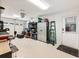 Well lit garage with roll up door, epoxy floors, and custom tools at 3965 Hamilton View Way, Dacula, GA 30019
