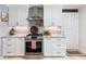 Bright kitchen features stainless steel appliances, ample white cabinets, and stone countertops at 3965 Hamilton View Way, Dacula, GA 30019