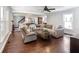 Open concept living room with hardwood floors, comfortable seating, and natural light at 3965 Hamilton View Way, Dacula, GA 30019