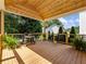 Covered patio features a wood ceiling and floor with a grill, plants, and metal railing, offering outdoor living space at 3965 Hamilton View Way, Dacula, GA 30019