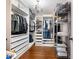 Organized walk-in closet features custom shelving, drawers, hanging racks and decorative chandelier for optimal clothing storage at 3965 Hamilton View Way, Dacula, GA 30019