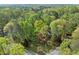 Aerial view showcases the home nestled in a lush, green forested area at 5269 Blue Grass Ln, Sugar Hill, GA 30518