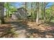 Driveway leads to the back of the house with wooded area around the property at 5269 Blue Grass Ln, Sugar Hill, GA 30518
