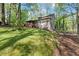 Expansive backyard with grassy lawn and tall trees offers privacy and space for outdoor activities at 5269 Blue Grass Ln, Sugar Hill, GA 30518