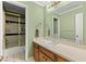Green bathroom featuring a single sink vanity and shower at 5269 Blue Grass Ln, Sugar Hill, GA 30518