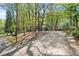 Long driveway leading to a home surrounded by mature trees provides privacy and seclusion at 5269 Blue Grass Ln, Sugar Hill, GA 30518