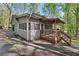 Exterior view of home with a deck and a screened in porch at 5269 Blue Grass Ln, Sugar Hill, GA 30518