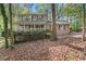 Charming two-story home with a cozy front porch and mature trees at 5269 Blue Grass Ln, Sugar Hill, GA 30518