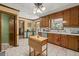 Classic kitchen with wood cabinetry, a tile floor, and stainless steel appliances at 5269 Blue Grass Ln, Sugar Hill, GA 30518