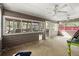Empty screened in porch featuring ceiling fans and lots of natural light at 5269 Blue Grass Ln, Sugar Hill, GA 30518
