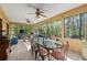 Bright sunroom with a tile floor, many windows, and a large dining table at 5269 Blue Grass Ln, Sugar Hill, GA 30518
