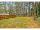 Fenced backyard with a shed, offering privacy and additional storage space at 7660 Brentwood Ct, Cumming, GA 30040