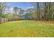 Spacious backyard with a deck and privacy fence on a sunny day at 7660 Brentwood Ct, Cumming, GA 30040