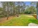 Expansive fenced backyard featuring a fire pit, providing a serene outdoor space for relaxation at 7660 Brentwood Ct, Cumming, GA 30040
