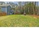 Large backyard with a fire pit, deck, and fenced perimeter at 7660 Brentwood Ct, Cumming, GA 30040