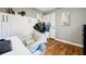 Neutral bedroom featuring hardwood floors, a built in white cabinet, and an octopus picture on the wall at 7660 Brentwood Ct, Cumming, GA 30040