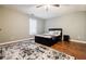 Bedroom with hardwood floors, ceiling fan, and a modern bed frame and decor at 7660 Brentwood Ct, Cumming, GA 30040