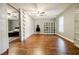 Bedroom space featuring hardwood floors, ceiling fan, and a large open area at 7660 Brentwood Ct, Cumming, GA 30040