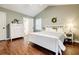 Serene bedroom with wood floors, a white bed, and natural light, offering a peaceful retreat at 7660 Brentwood Ct, Cumming, GA 30040