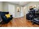 This bedroom features hardwood floors, neutral walls, and a comfortable sitting area at 7660 Brentwood Ct, Cumming, GA 30040