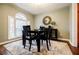 Dining room features natural light, a decorative mirror, and hardwood floors at 7660 Brentwood Ct, Cumming, GA 30040