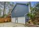 The rear of the home shows a two-car garage, with a small deck above, and a fenced-in yard at 7660 Brentwood Ct, Cumming, GA 30040