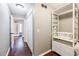 Hallway with wood floors features a closet and built in storage at 7660 Brentwood Ct, Cumming, GA 30040