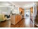 Open layout kitchen with stainless steel appliances flowing to dining and living rooms at 7660 Brentwood Ct, Cumming, GA 30040