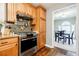 Charming kitchen with granite countertops, tile backsplash, stainless steel appliances, and wood cabinets at 7660 Brentwood Ct, Cumming, GA 30040