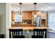 Open concept kitchen with granite countertops, stainless steel appliances, and wood cabinets at 7660 Brentwood Ct, Cumming, GA 30040
