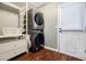 Laundry room with stacked washer and dryer and exterior access door at 7660 Brentwood Ct, Cumming, GA 30040