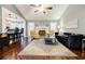 Bright living room with a vaulted ceiling, fireplace, view to breakfast bar, and contemporary furnishings at 7660 Brentwood Ct, Cumming, GA 30040