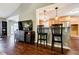 Stylish living room featuring wood floors, a breakfast bar, and an open-concept design at 7660 Brentwood Ct, Cumming, GA 30040