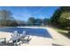 Community pool covered for the off-season, featuring lounge chairs and shaded seating areas at 7660 Brentwood Ct, Cumming, GA 30040