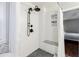 Modern shower features white subway tile, a built-in seat, dark fixtures, and herringbone tile accent at 7660 Brentwood Ct, Cumming, GA 30040