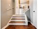 Staircase with hardwood steps and white risers, leading to the upper level of the home at 7660 Brentwood Ct, Cumming, GA 30040