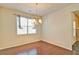 Bright dining room featuring hardwood floors, modern lighting fixture and a large window at 234 Madison Ave, Acworth, GA 30102