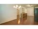 Open concept space featuring hardwood floors, updated lighting and a view of the kitchen at 234 Madison Ave, Acworth, GA 30102