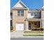 Inviting townhome featuring a brick facade, garage, and landscaped front yard at 234 Madison Ave, Acworth, GA 30102