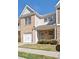Charming townhome with brick facade, garage, and welcoming front porch at 234 Madison Ave, Acworth, GA 30102