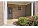 Close-up of the front porch with a decorated gray front door and colorful flower bed at 234 Madison Ave, Acworth, GA 30102