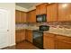 Kitchen with granite countertops, black appliances, and hardwood floors at 234 Madison Ave, Acworth, GA 30102