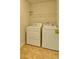 Functional laundry room features a side-by-side washer and dryer with tile flooring at 234 Madison Ave, Acworth, GA 30102