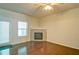 Cozy living room with hardwood floors, a modern ceiling fan, and a stone fireplace at 234 Madison Ave, Acworth, GA 30102