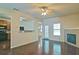 Open-concept living room with hardwood floors, fireplace, and kitchen pass-through at 234 Madison Ave, Acworth, GA 30102