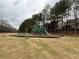 Community playground with swings, slides, climbing features, and benches lined by trees at 234 Madison Ave, Acworth, GA 30102